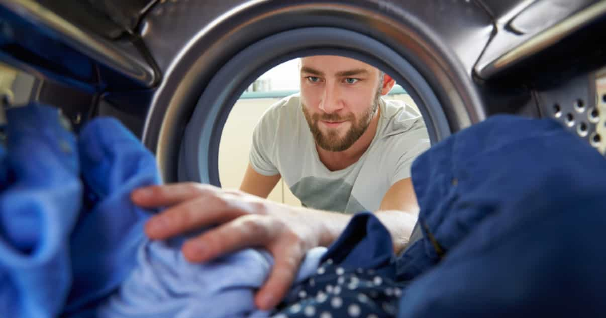 Man doing laundry in order to prevent jock itch