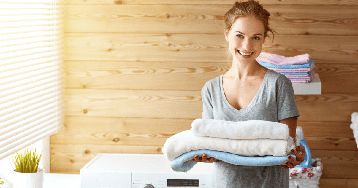 Woman holding her clean towels in the laundry room to prevent jock itch